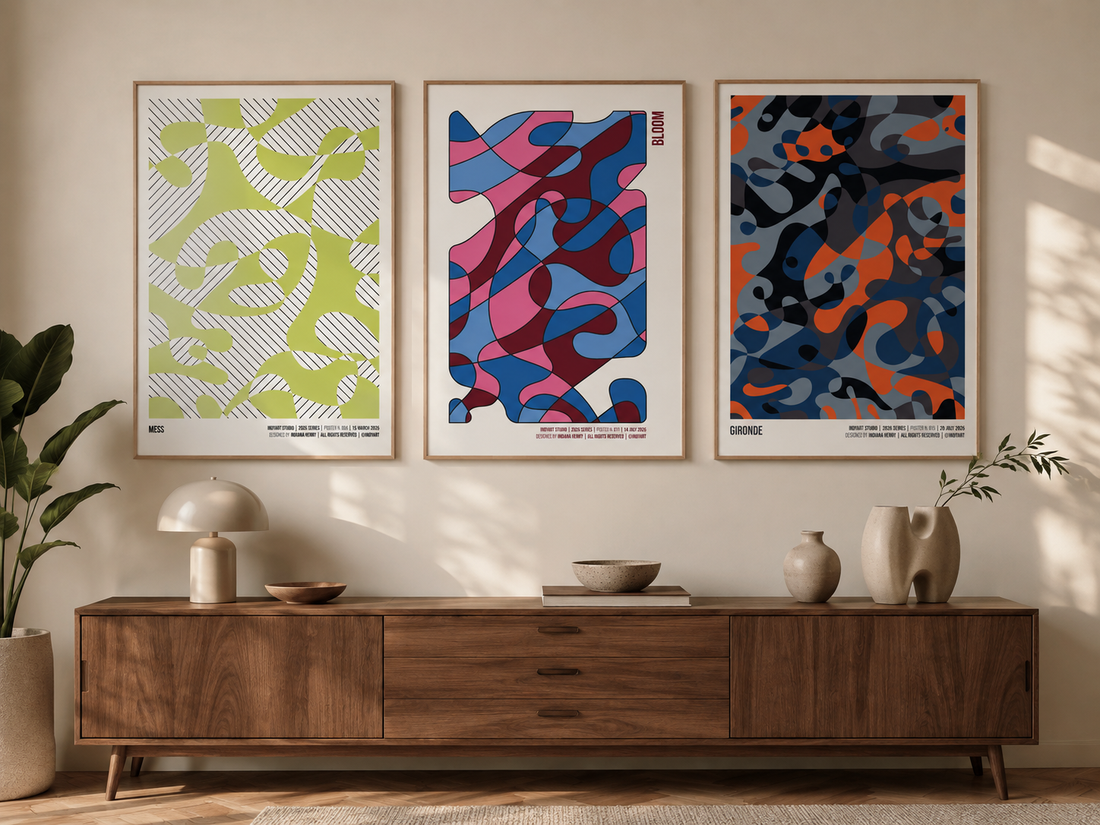 Three colorful abstract Indy Art Studio posters displayed above a mid-century wooden sideboard in a warm modern interior.