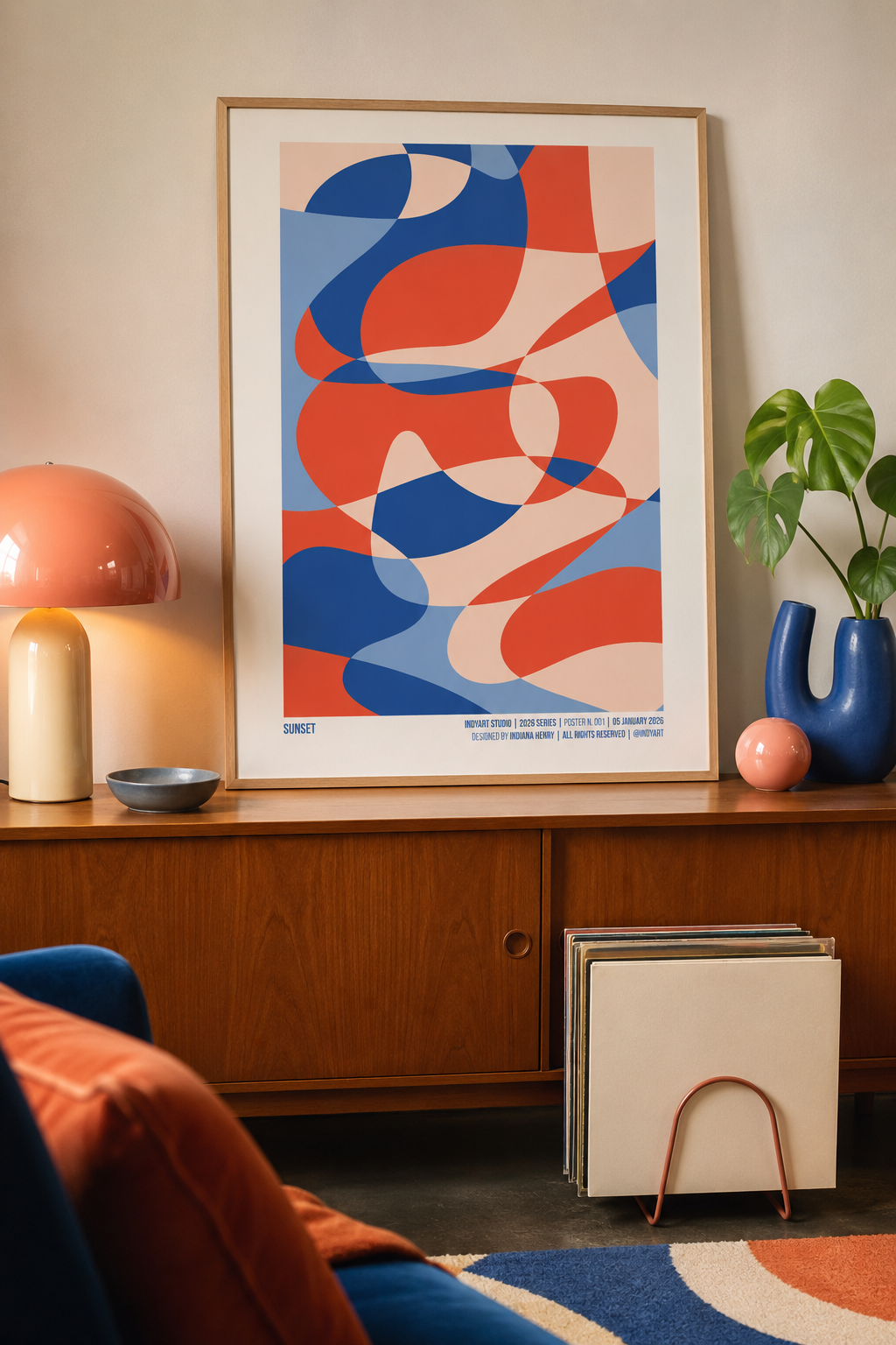 Sunset A2 poster displayed in a warm mid-century living room with blue and coral decor