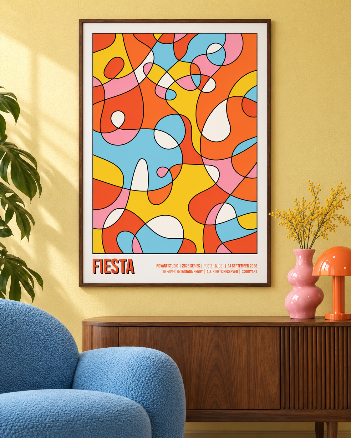 Fiesta colorful abstract A2 poster styled on a yellow wall above a walnut sideboard with a blue chair and pink vase.
